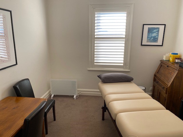 Fully equipped, modern allied health consulting room featuring flexible layouts, practitioner desks, and treatment tables.